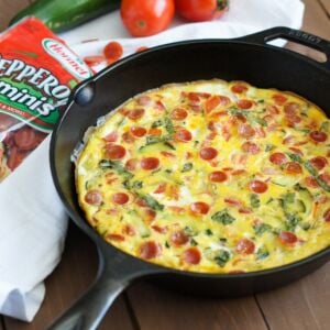 A pepperoni and vegetable frittata in a cast iron skillet.