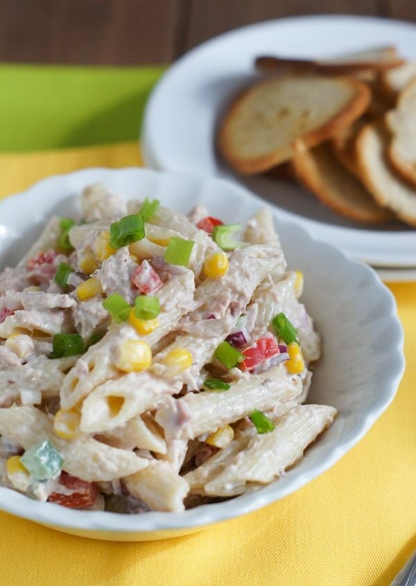 Tuna penne pasta salad served in a white bowl.