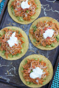 Overhead shot of four tostadas with chipotle chicken topping.