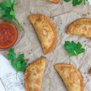 Pepperoni Pizza Empanadas - Crunchy on the outside, cheesy and gooey on the inside. The perfect easy snack or appetizer for any occasion.