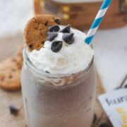 A chocolate chip cookie smoothie topped with whipped cream.