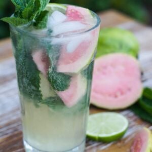 A guava mojito serve in a tall glass with fresh mint garnish.
