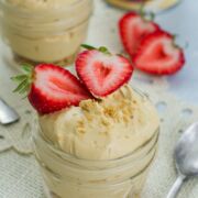 No bake cheesecake in a jar topped with strawberries.