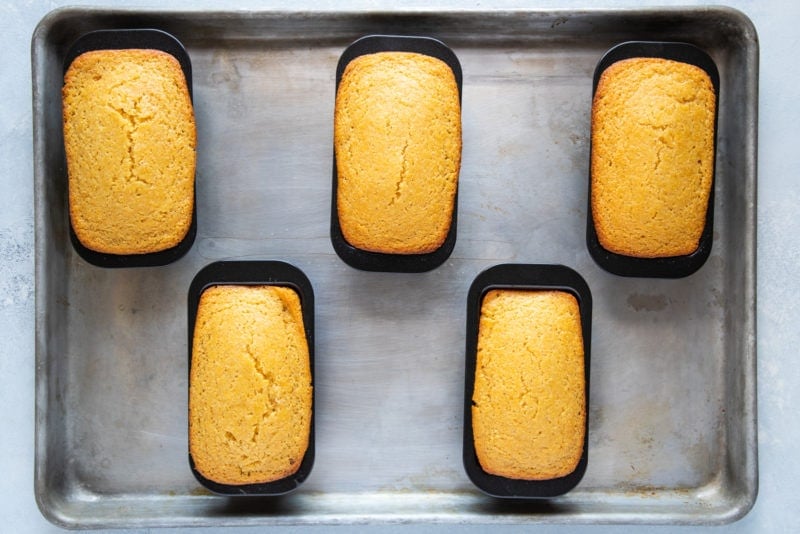 The loaves of cornbread in tins after being baked.