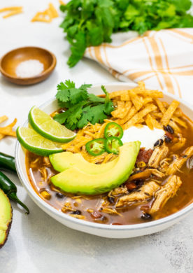 easy Instant Pot Chicken Tortilla Soup is filled with spicy flavors, shredded chicken, black beans, fire roasted tomatoes, and corn.