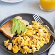 Soft and fluffy scrambled eggs with ham and cheese
