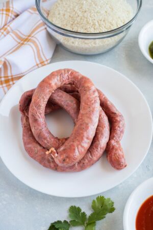 Uncooked Dominican Longaniza on a plate