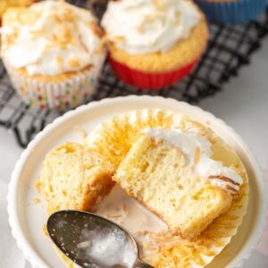 coconut tres leches cupcake on a white plate