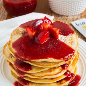 strawberry pancakes with homemade strawberry sauce over the top