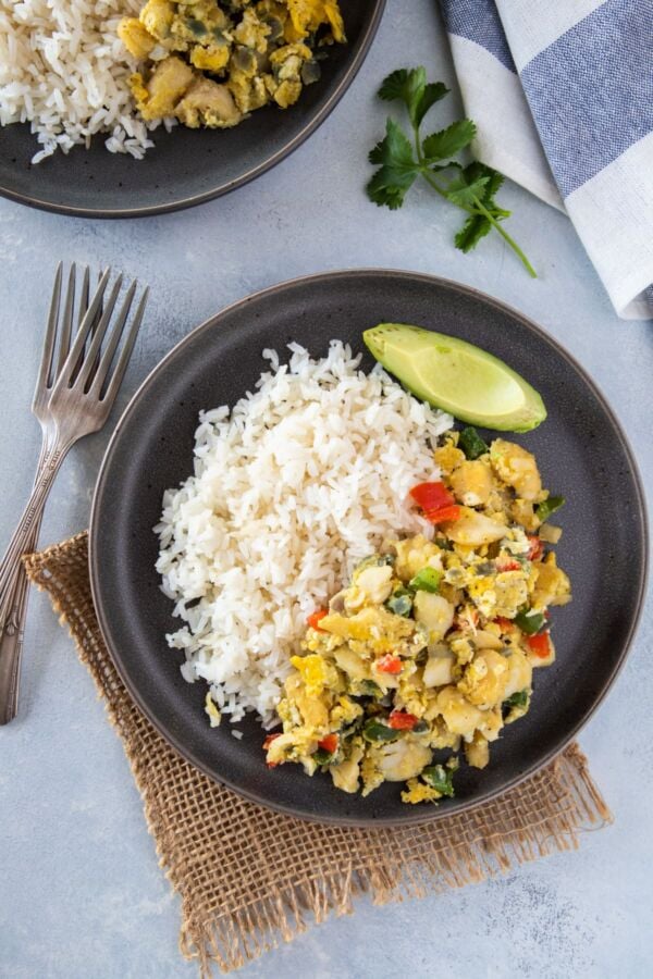 Bacalao con huevos served on a gray plate ready to eat