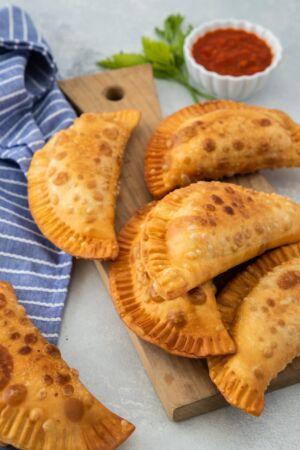 Pepperoni Pizza Empanadas on a board