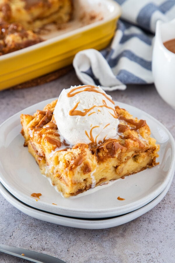 slice of bread pudding topped with vanilla ice cream ready to eat