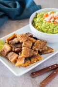 Crispy chicharrón served with creamy guacamole—perfectly golden bites with a flavorful dip.