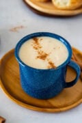 Creamy Dominican hot oatmeal topped with cinnamon in a blue mug.