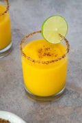 Frozen mango margarita with a chili-salt rim and lime slice garnish.